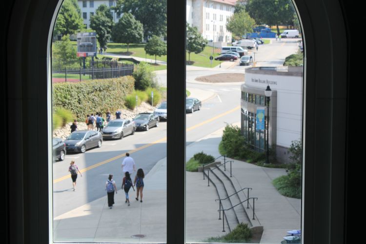 students running visible through a window